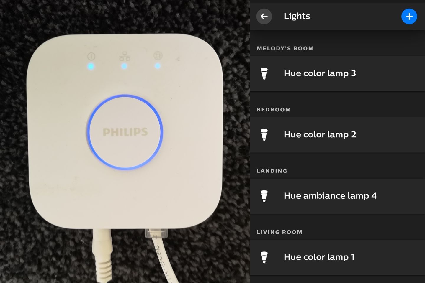 Philips smart lighting hub with blue indicator lights and room lamp settings