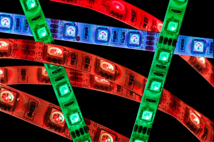 Colorful LED light strips in red, green, and blue arranged in a dynamic pattern.