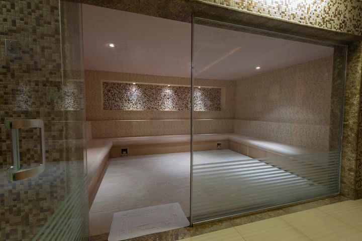 A serene spa room with soft LED lighting and smooth tile surfaces.
