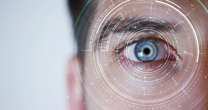 Close-up of a human eye surrounded by digital interface graphics.