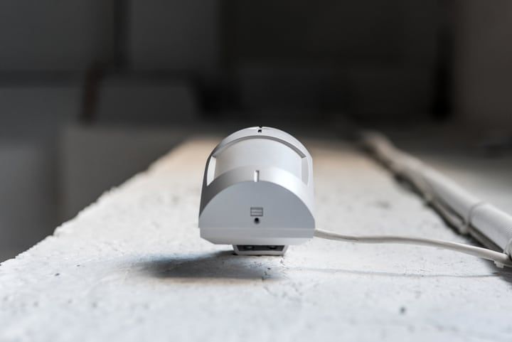 A compact, cylindrical LED light fixture on a white surface.
