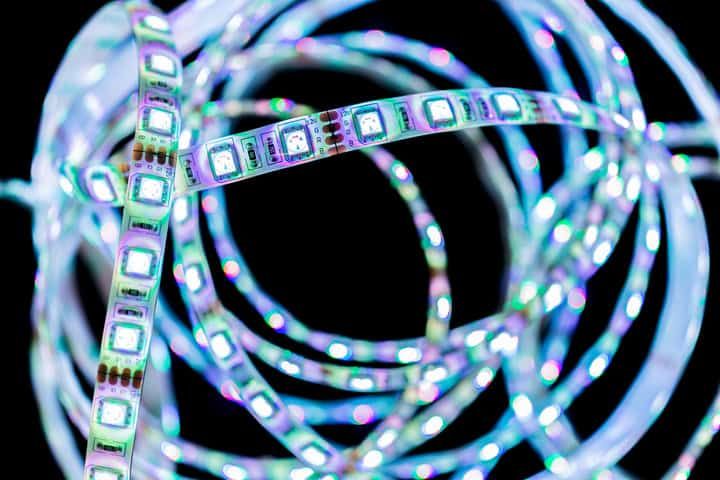 Colorful LED light strips coiled together against a dark background.