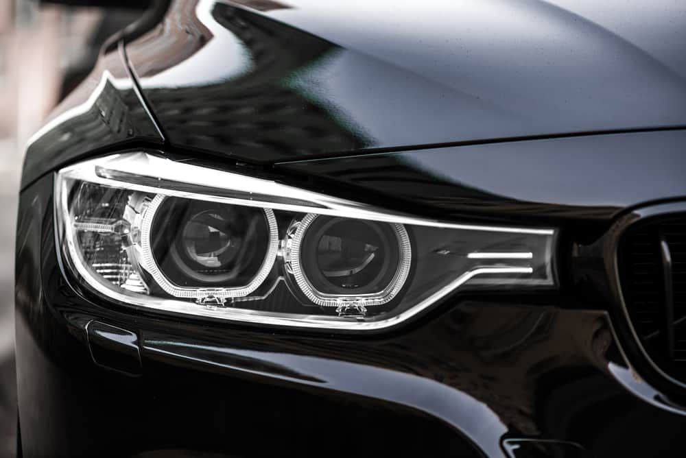 Close-up view of sleek black car headlights showcasing modern LED technology.