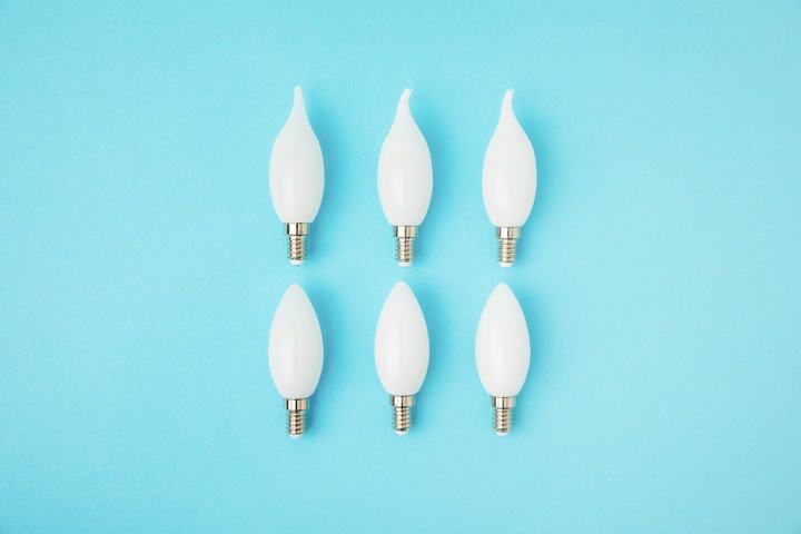Six white LED light bulbs arranged in two rows on a blue background.