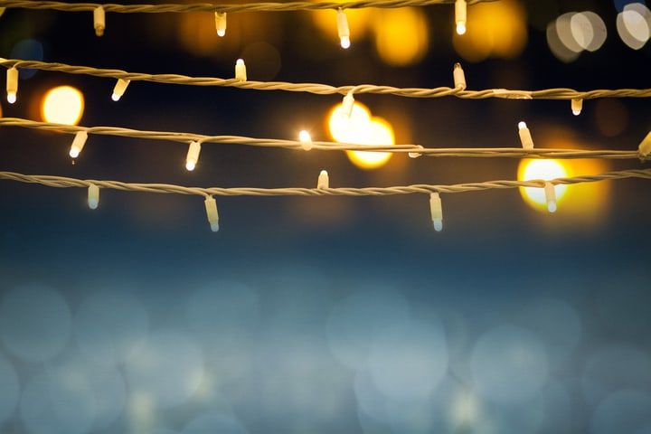 Strings of warm white LED lights against a blurred dark background.