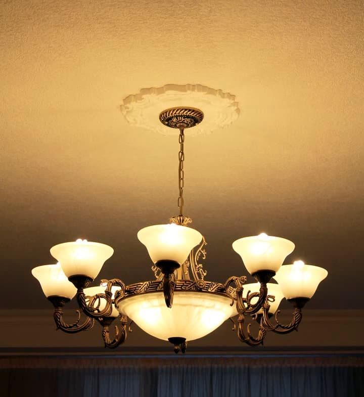 Elegant chandelier with multiple glass shades illuminating a room.