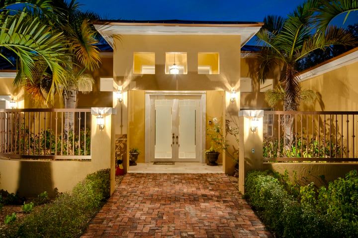 Stylish entrance of a house illuminated by warm LED lighting at night.