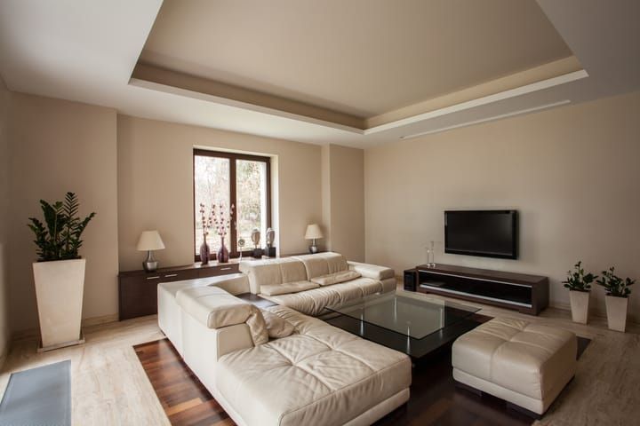 Modern living room with cream-colored furniture and ambient LED lighting.