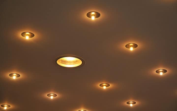 Ceiling lights with warm glow embedded in a flat surface.