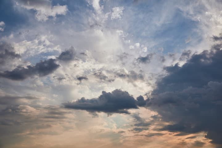 Dramatic sky filled with varied clouds and soft light at dusk.