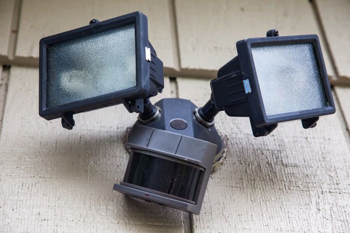Two rectangular LED floodlights mounted above a motion sensor.