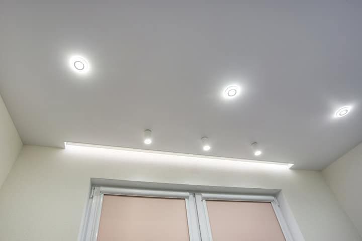 Modern ceiling featuring recessed LED lights and soft ambient illumination.
