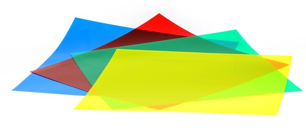 Colorful sheets of transparent plastic in various hues layered together.