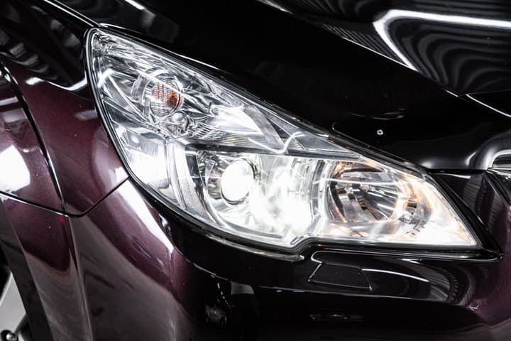 Close-up of a car's LED headlight on a dark vehicle.