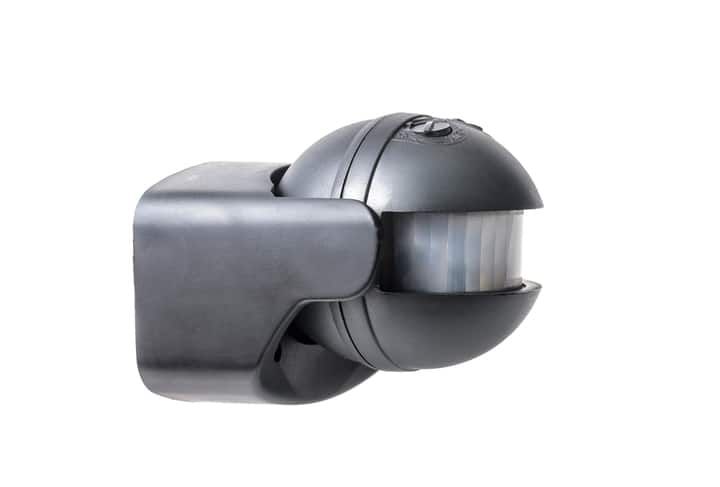 Black LED motion sensor light fixture mounted on a wall.