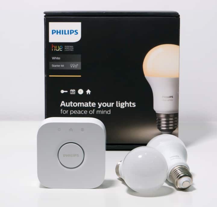 Philips Hue starter kit with smart bulbs and control hub on display.