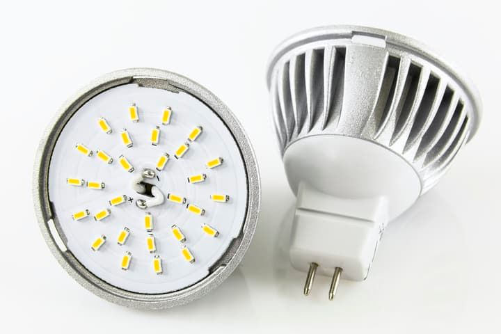 Close-up of two LED light bulbs with multiple yellow lights and a connector.