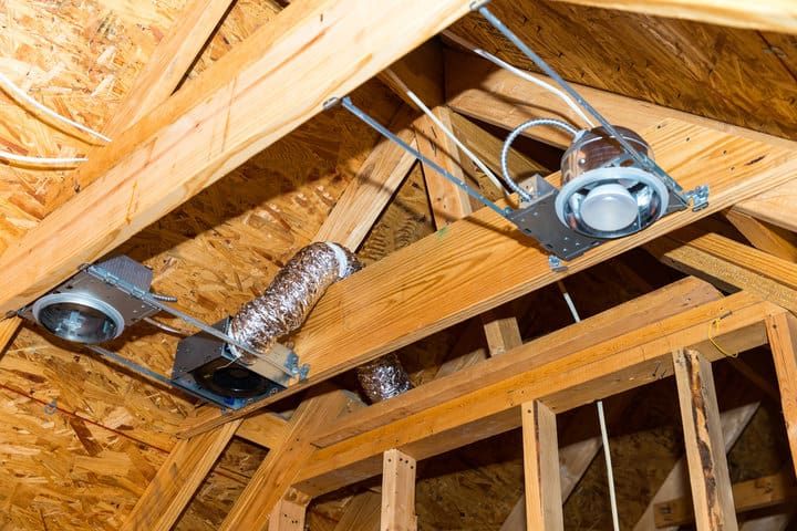 Ceiling beams with recessed LED lights and ductwork visible in the frame.