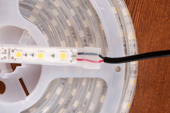 Close-up of an LED strip with visible lights and wiring connection.