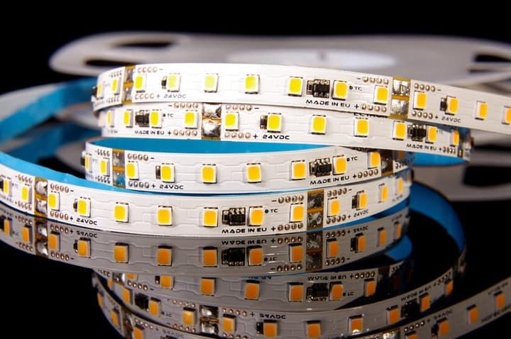 Close-up of LED light strips showing bright yellow lights on a flexible circuit.