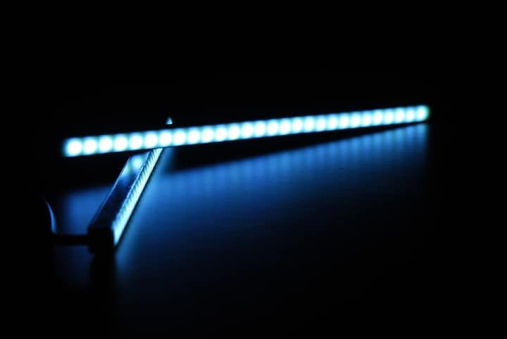 Bright blue LED light strip against a dark background.