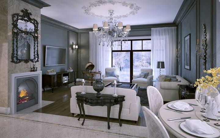 Luxurious living room featuring elegant furniture and a chandelier.