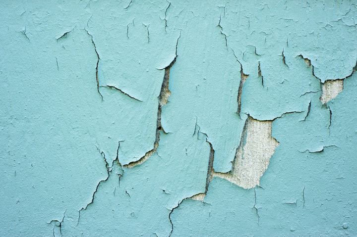 Peeling blue paint revealing a textured underlying surface