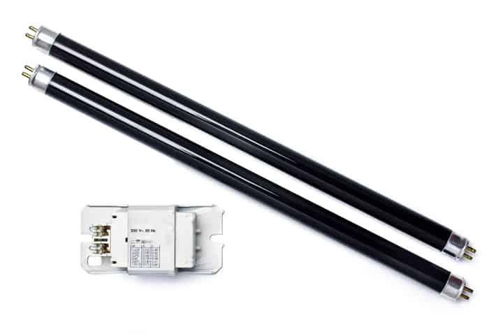 Two black LED light tubes and a white electronic ballast on a white background.