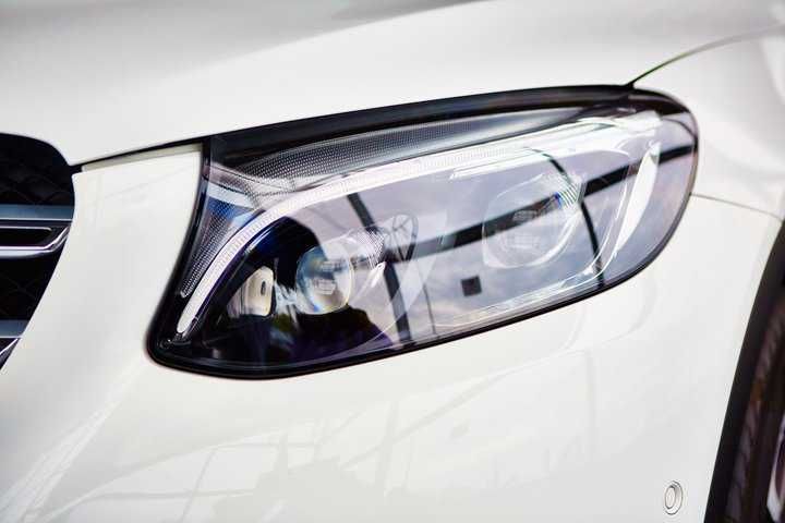 Close-up of a car's modern LED headlight design with intricate details.