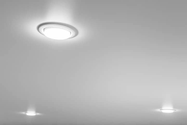 Ceiling lights illuminate a smooth ceiling, creating a bright atmosphere.