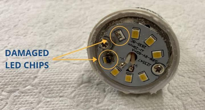 Close-up of an LED bulb showing damaged chips on the base.