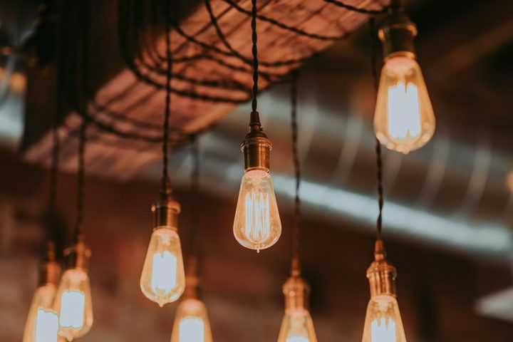 Warm, vintage-style LED bulbs hanging from a wooden beam.