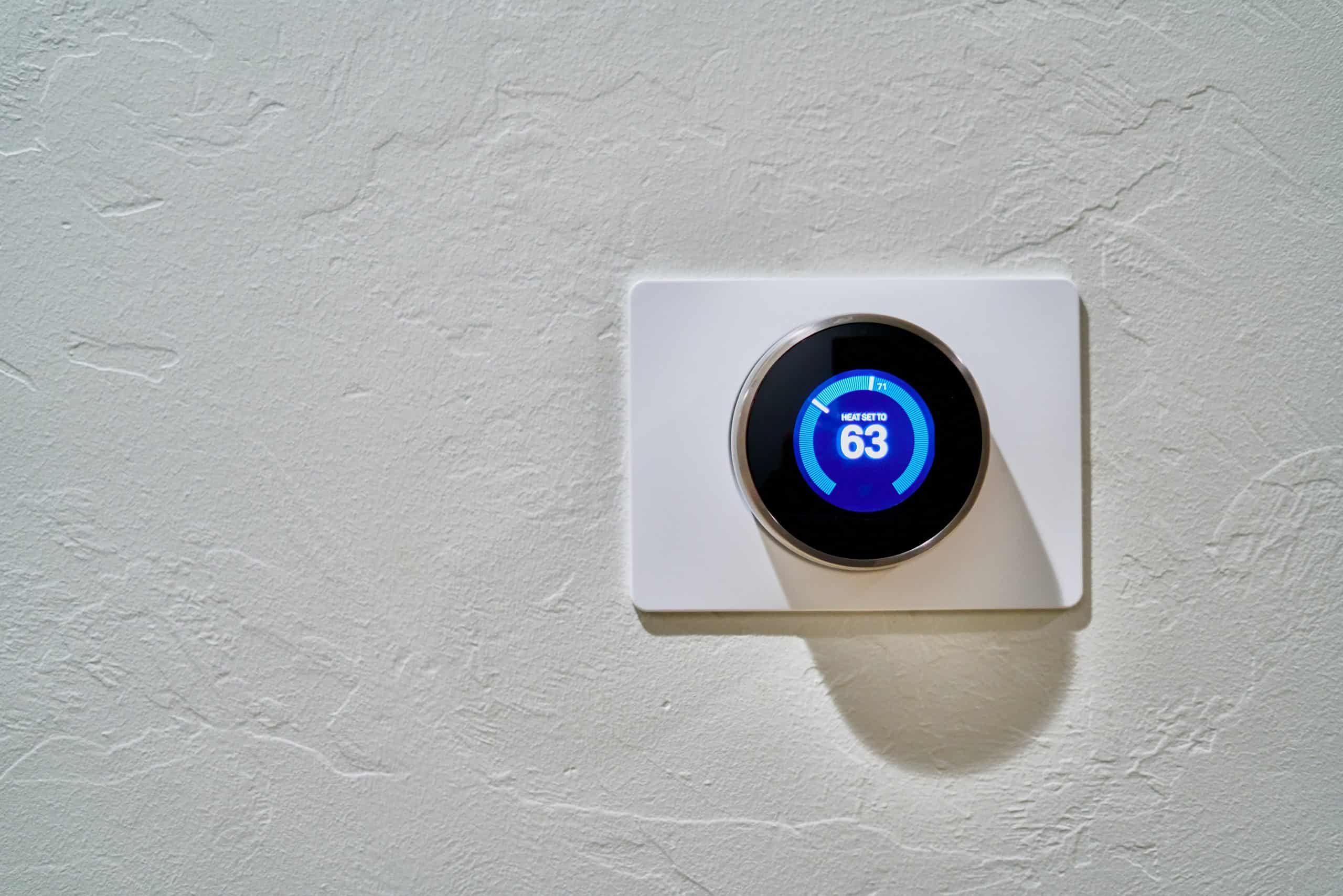 Smart thermostat displaying a temperature setting of 63 degrees Fahrenheit.