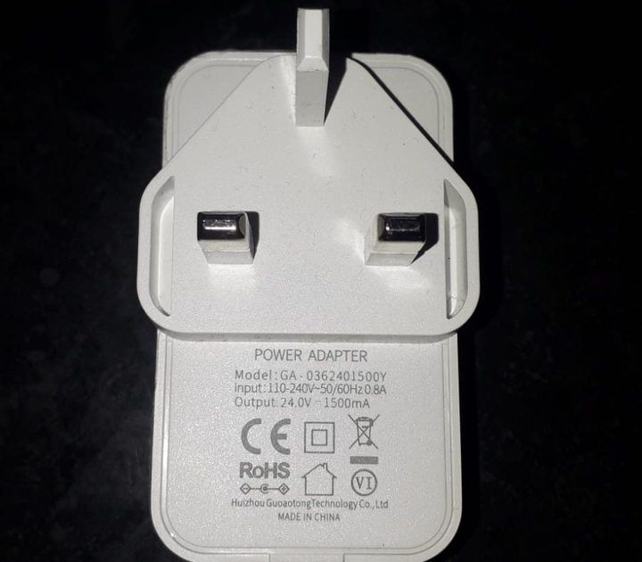 White power adapter with two prongs and technical specifications detailed below.
