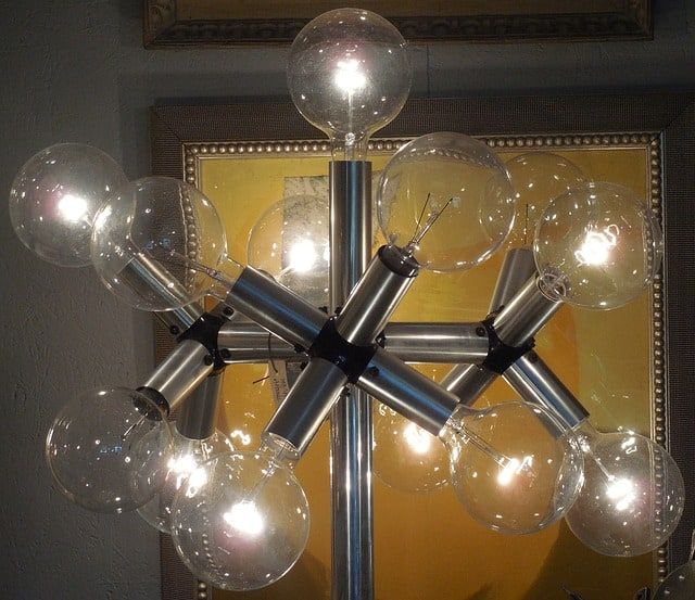 Modern chandelier with multiple clear glass bulbs and metal arms.