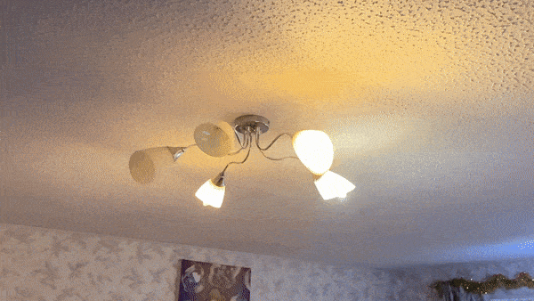 Ceiling light fixture with four bulbs shining in different directions.