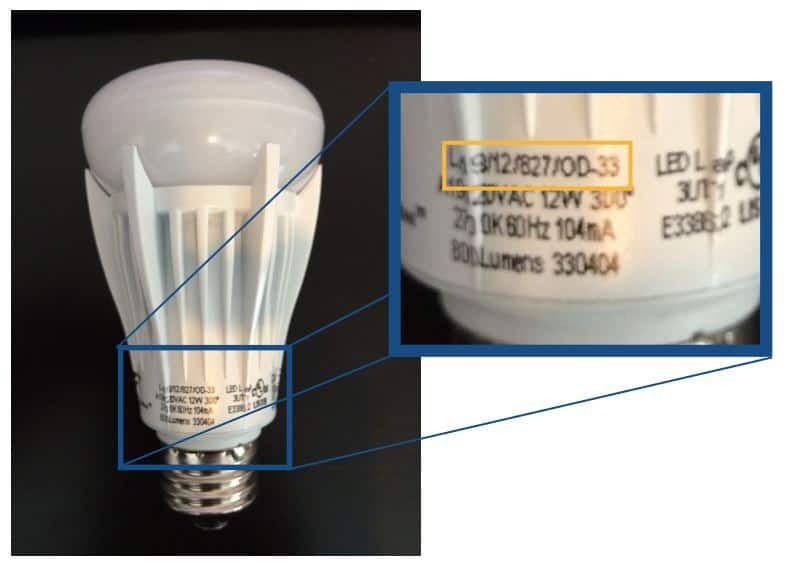Close-up of an LED bulb showcasing labels and specifications on the base.