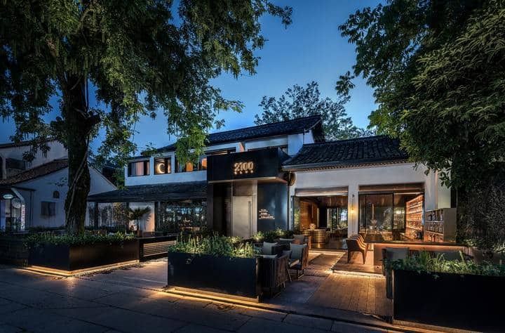 Elegant restaurant exterior illuminated by warm LED lights at dusk.