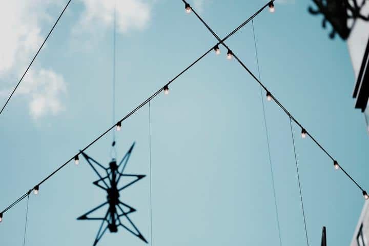 String lights are strung across a blue sky with a star-shaped decoration.