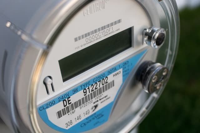 Close-up of a digital electric meter with display and labels.