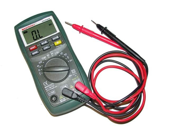Digital multimeter with red and black test leads for measuring electrical values.