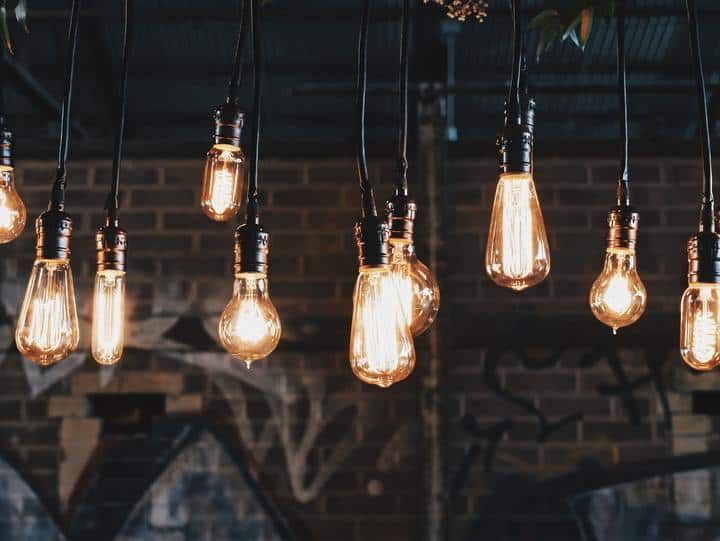 A cluster of vintage-style LED light bulbs hanging from black cords.