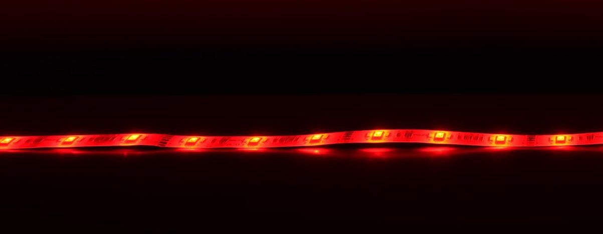 A vibrant red LED strip light glowing against a dark background.
