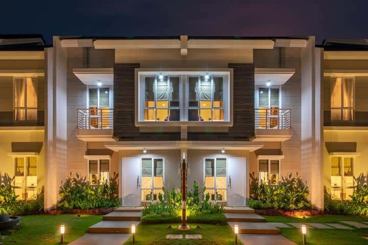 Modern two-story building illuminated by LED lights at night.