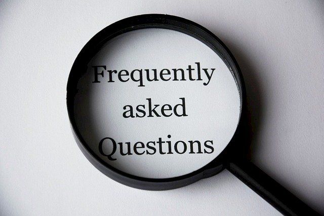 A magnifying glass focuses on text reading 'Frequently asked Questions'.