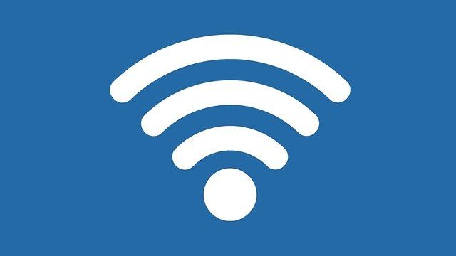 White Wi-Fi symbol on blue background representing wireless connectivity